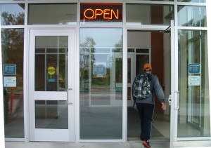 Front doors of the library. 2 doors separated by a 3 foot pane of window glass. Handicap access door is on the left.