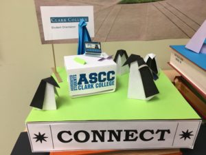 origami penguins gather around an ASCC welcome desk near a sign reading "Connect"
