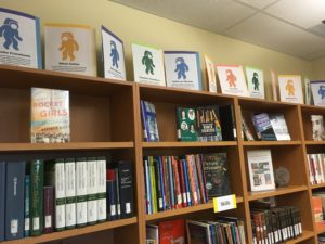 A row of books about women in science, math, and engineering, with small profiles of female astronauts.