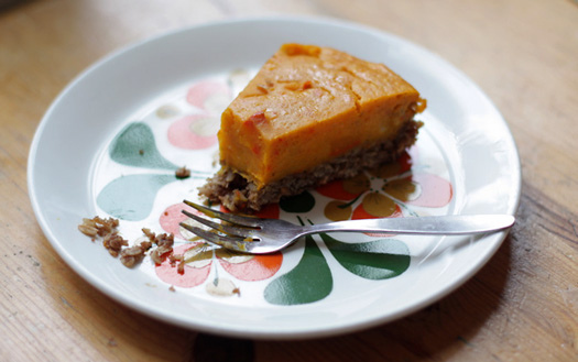 pumpkin pie with one bite taken off on plate with fork