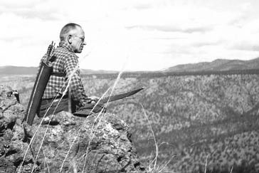 Photo of Aldo Leopold sitting on Rimrocks in 1938