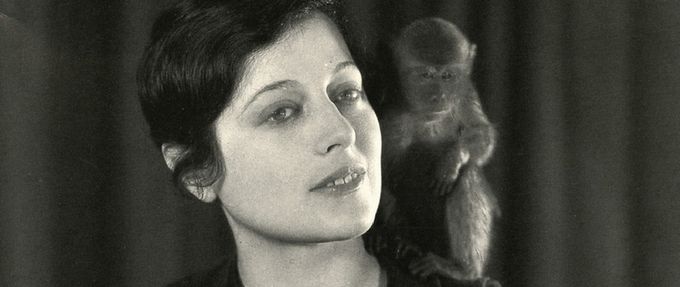 Photo of Emily Hahn with a pet monkey on her shoulder
