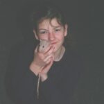 10 year old Laura holding a tan rat