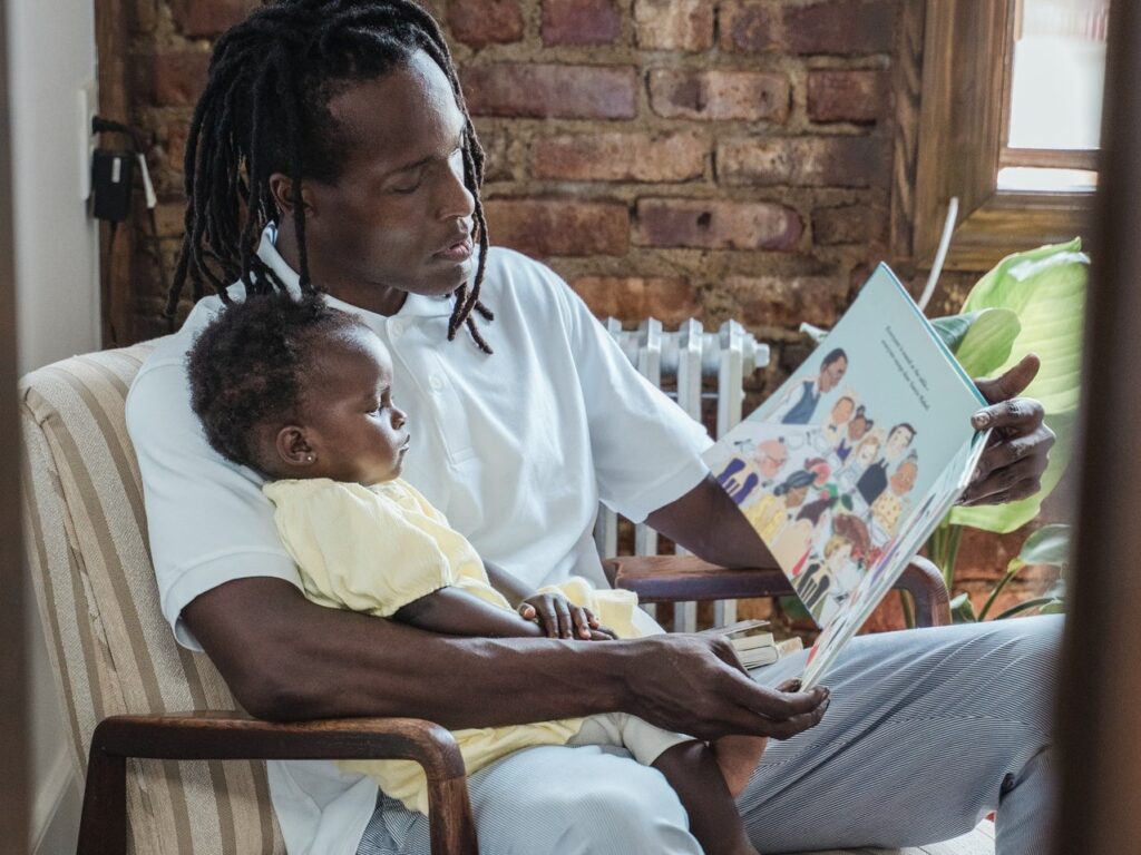 Black father and daughter reading