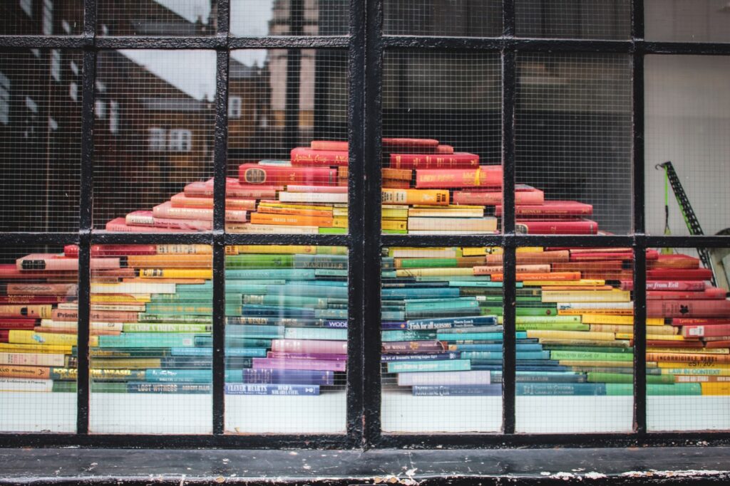 Books forming a rainbow in a window