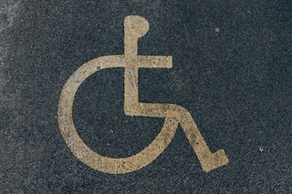 the symbol of access: a line painting of a person in a wheelchair