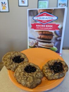 The Treats Truck cookbook and oatmeal cookies on a plate