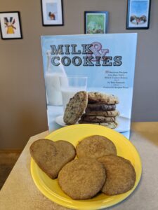 Milk & Cookies cookbook with brown sugar-cinnamon cookies on a plate