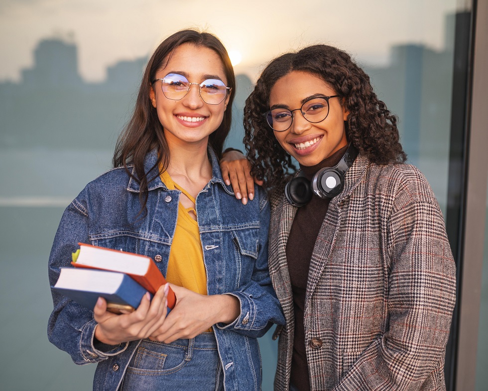 Smiley friends pose together holding books