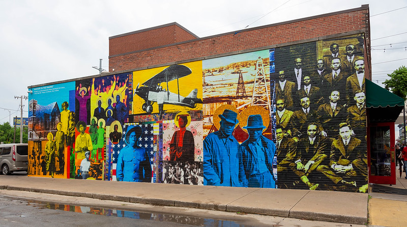 Colorful mural depicting Black people throughout history in a variety of settings