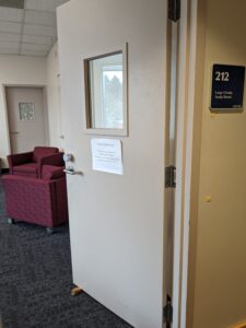 Open door to Family Study Room, LIB 212, showing comfy chairs