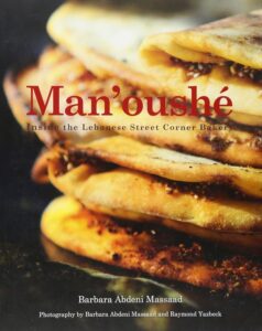 Stacked manakish on the cover of the book titled Manoushe