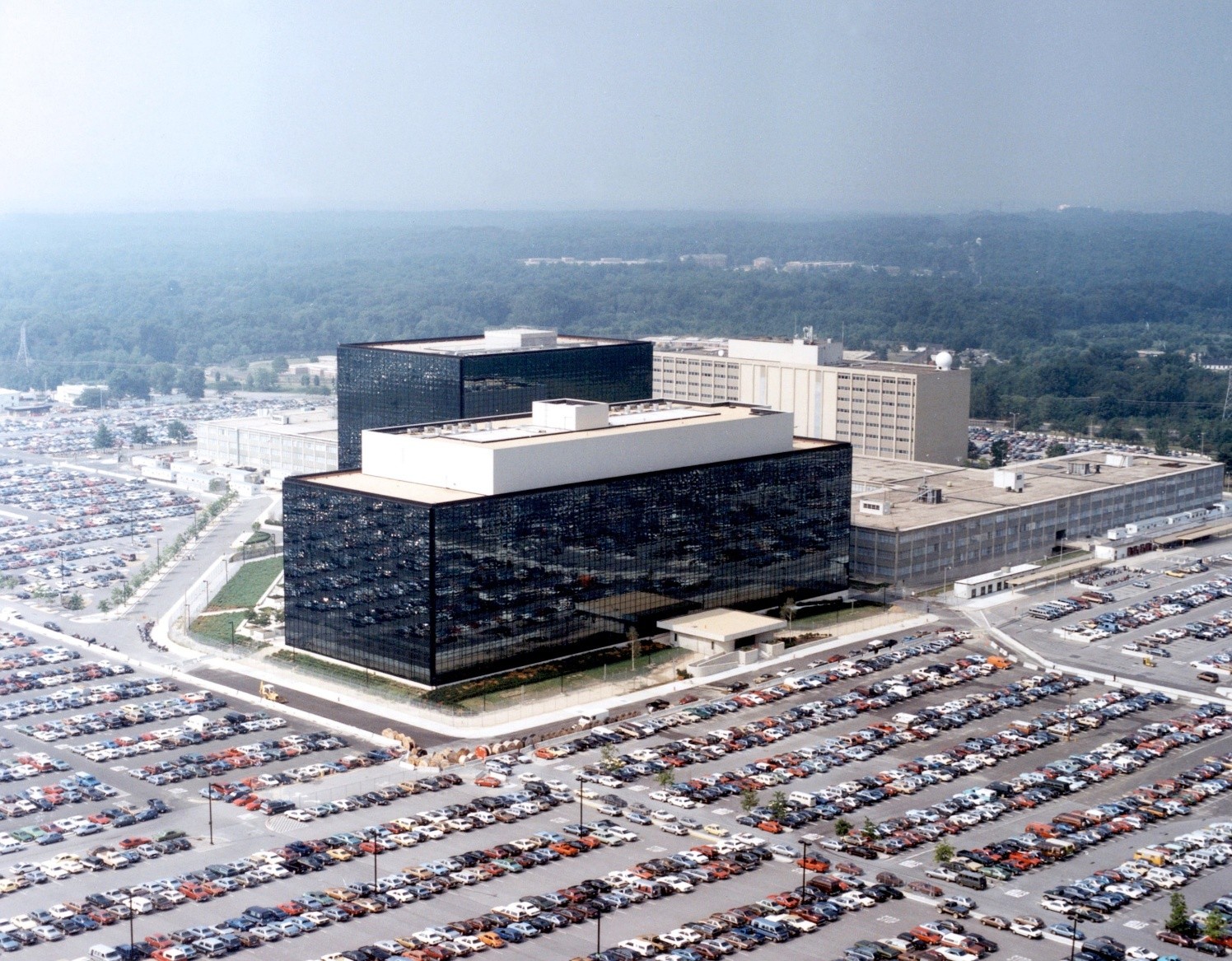 Aerial photograph of the black, reflective, and angular buildings of NSA's headquarters