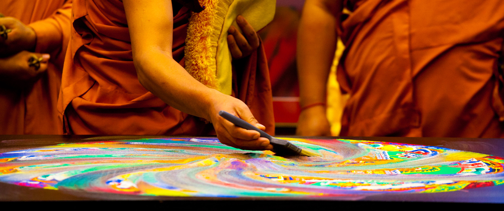 monks destroy a sand mandala